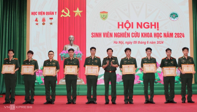 Trung tướng, PGS.TS Nguyễn Xuân Kiên (giữa) trao giải cho đại diện tác giả nhóm đoạt giải nhất. Ảnh: Như Quỳnh
